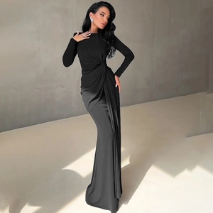 Detailed view of elegant ruched knot design on waist of black long-sleeved evening gown