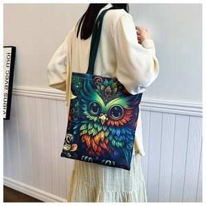 Detailed close-up of canvas tote bag featuring colorful artistic owl print design