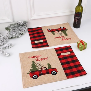 Christmas placemats with red truck embroidery and black plaid linen textures