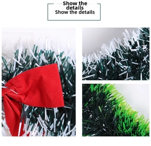 Detail of red velvet bow and green white Christmas garland strips for holiday decor