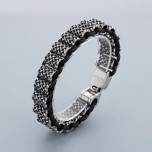 Detailed macro view of 316L stainless steel buckle on black braided leather bracelet