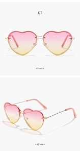 Detailed front and 45-degree side views of gold heart sunglasses with pink gradient lenses