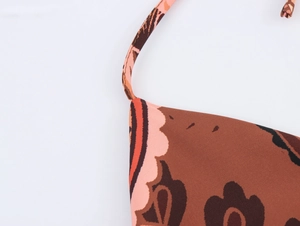 Detail shot of brown floral print fabric and shoulder strap stitching on a summer set