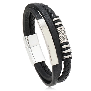 Detail of black braided PU leather bracelet with silver Celtic knot charm and magnetic clasp