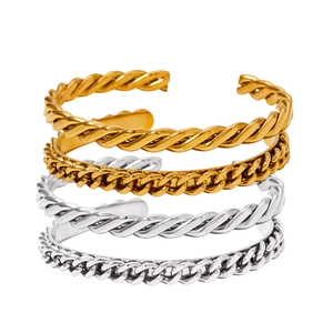 Stack of gold and silver twisted cable cuff bracelets in polished stainless steel