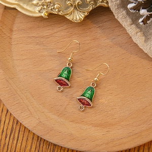Detail of festive Christmas bell drop earrings with red and green enamel and small yellow gems