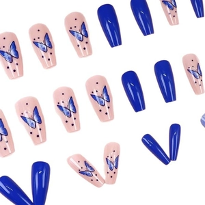 Long coffin false nails with blue butterfly patterns and polka dots on a white background