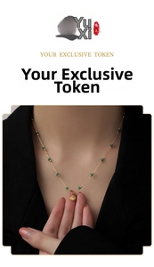 Close-up of gold titanium necklace with emerald beads and shell pendant on a model