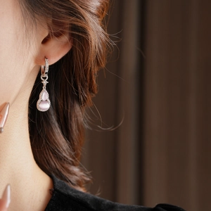 Detail of silver drop earring with pink opal gourd pendant and sparkling zircons