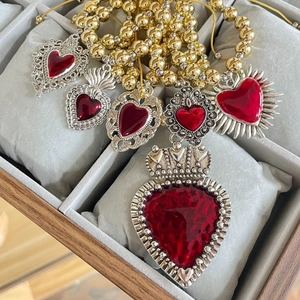 Retro sacred heart pendants with red resin inlay on a silver frame and golden bead chain
