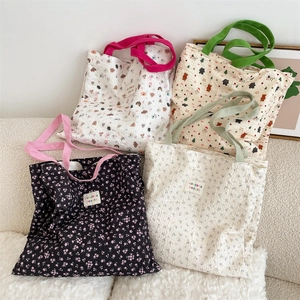 Collection of quilted floral and animal pattern tote bags on a textured sofa