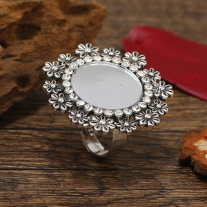 Bohemian retro floral ring with crystals and silver finish on vintage wood background