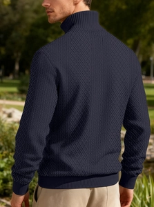 Detail of navy blue men's sweater showing high-density 3D knit diamond texture and patterns