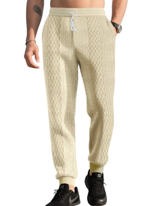 Detail of men's waffle knit joggers featuring drawstring waist and elastic cuffs in beige