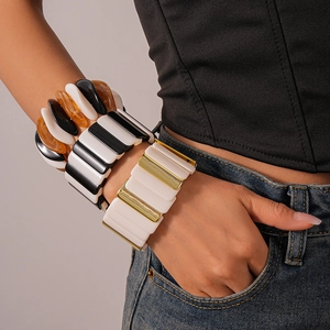 Detail of wide acrylic and alloy geometric stretch bracelet with black and white resin contrast