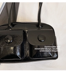 Detail of black glossy crinkled faux leather shoulder bag with two front flap pockets