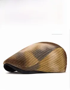Detail view of khaki tie-dye knitted newsboy hat with black visor contrast