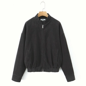 Close-up of charcoal grey corduroy jacket featuring a full zipper and stand collar