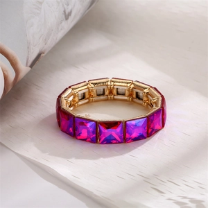Macro view showing geometric rose purple crystals set in gold-tone elastic alloy frame