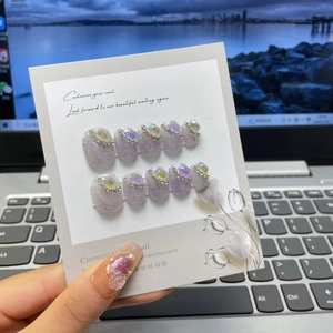 Detailed view of handmade baroque purple glitter press-on nails with pearls and crystals