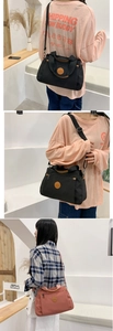 Detail of casual nylon handbag with multiple compartments and adjustable strap