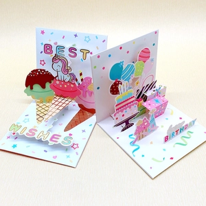 3D pop-up birthday cards with unicorn and cake designs on a textured background