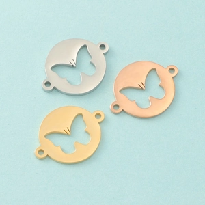 Detailed view of hollow butterfly charms in silver, gold, and rose gold finishes
