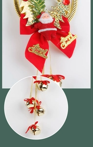 Detail of Christmas tree ornament with Santa doll, red bow and golden bells