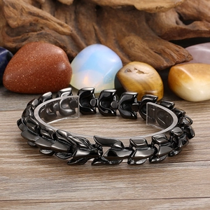 Close-up of black stainless steel dragon bone bracelet on a display stand