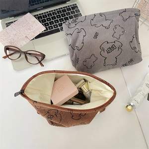 Detail of baby bear corduroy cosmetic bags in grey and brown with beige lining