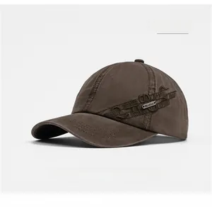Detail of coffee brown washed cotton baseball cap with vintage embroidery and metal logo