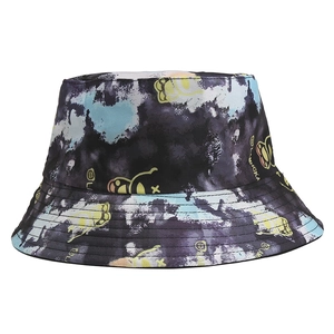 Detail of adult bucket hat featuring tie-dye pattern and cartoon graphics with text