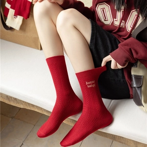 Red cashmere crew socks for women featuring white Keep your head up embroidery
