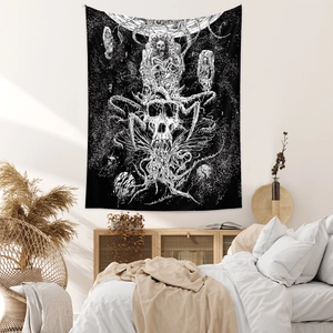 Detail of bohemian black and white skull tapestry hanging on a bedroom wall decoration