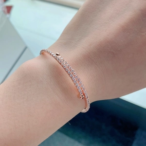 Rose gold double row zircon cuff bracelet on female wrist for a luxury fashion look