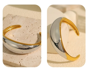 Detail showing the thick golden and silver mixed finish on the polished open bangle