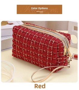 Nahaufnahme der roten Tweed-Kosmetiktasche mit goldenen Reißverschlüssen und H-Muster