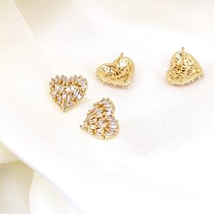 Gold plated hollow heart stud earrings with baguette-cut cubic zirconia and silk background