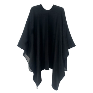 Detail shot of the black cashmere-like knit shawl showing decorative overlock edges