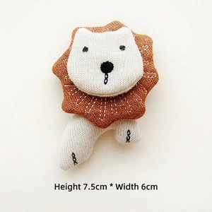 Detailed view of handmade stuffed fabric lion brooch with dimensions 7.5cm by 6cm
