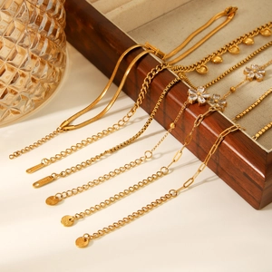 Golden stainless steel necklace set with zircon flower charms and elegant chain textures