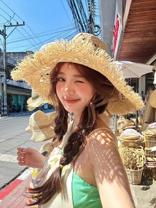 Detailed texture of raffia straw hat with frayed edges for summer sun protection