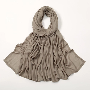 Detail of taupe modal scarf showing soft drape texture and fine stitched edges
