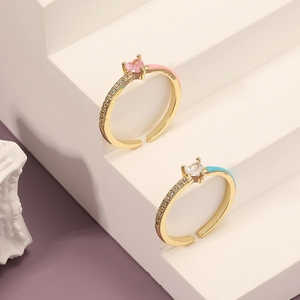 Pink and blue enamel heart rings with gold bands and sparkling cubic zirconia stones