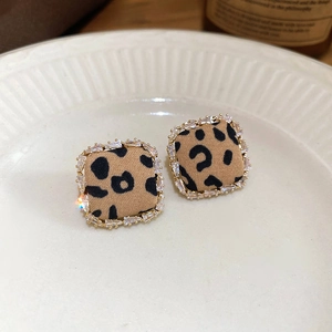 Macro shot of square leopard print earrings with sparkling cubic zirconia borders