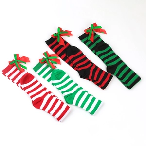 Detail of Christmas over-the-knee socks set featuring striped patterns and bow accents