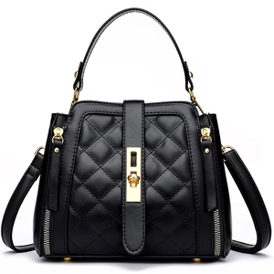 Elegant black quilted bucket bag with gold hardware and a top handle for stylish women