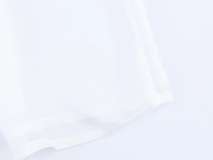 Detailed macro view of white elegant blouse fabric with vertical stripes and fine stitching