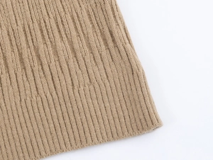Detailed close-up of camel knit fabric showing high-quality ribbed cuffs and texture