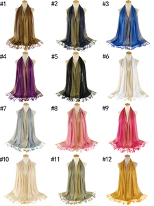 Detailed grid of twelve colorful scarves featuring geometric jacquard borders and long tassels